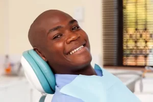 happy man in dentist chair smiling